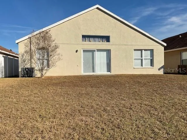 a view of yellow house with a yard