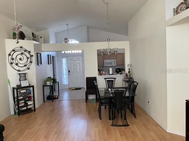 a view of a a dining room with furniture window and wooden floor