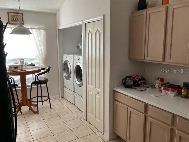 a utility room with sink dryer and washer