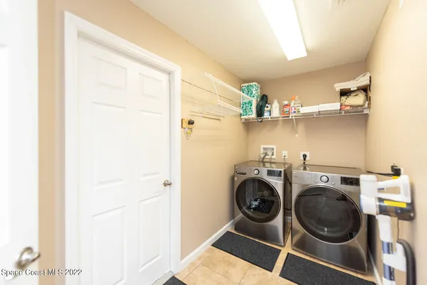 a view of storage and utility room with washer and dryer