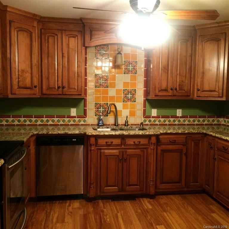 4521 Stack Road Monroe, NC 28112 - Photo 12 of 24 a kitchen with granite countertop wooden cabinets a sink and dishwasher