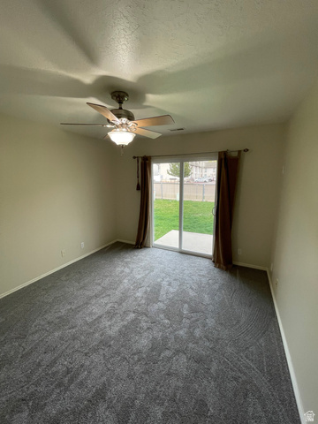 101 1501 Monroe, Unit 101 Ogden, UT 84404 - Photo 20 of 24 Carpeted empty room featuring a textured ceiling and ceiling fan