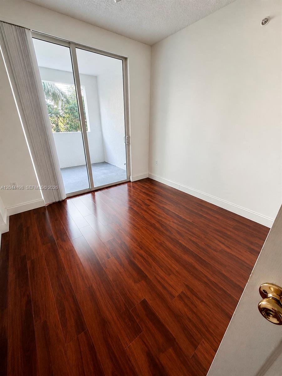 17145 North Bay Road, Unit 4307 Sunny Isles Beach, FL 33160 - Photo 14 of 35 a view of empty room with wooden floor and fan