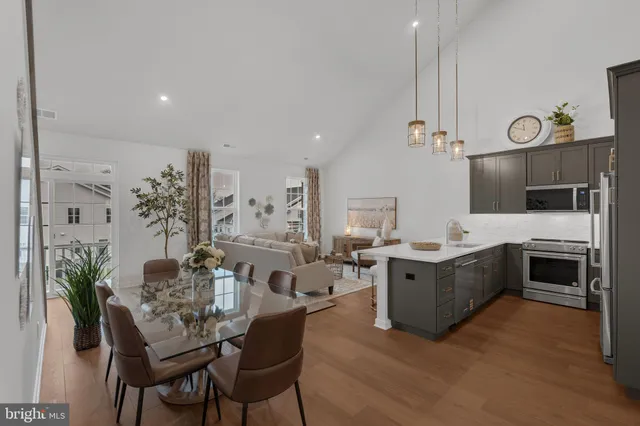 a large kitchen with a table and chairs