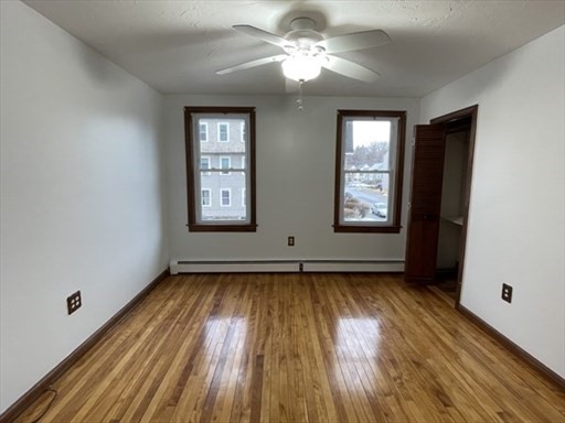 57 Vale Street, Unit 2 Worcester, MA 01604 - Photo 11 of 13 a view of an empty room with window and wooden floor