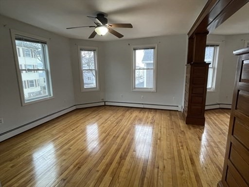 57 Vale Street, Unit 2 Worcester, MA 01604 - Photo 4 of 13 a view of an empty room with wooden floor and a window
