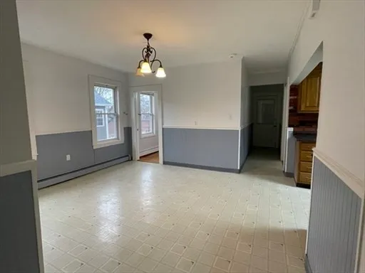 en empty room with windows and ceiling fan