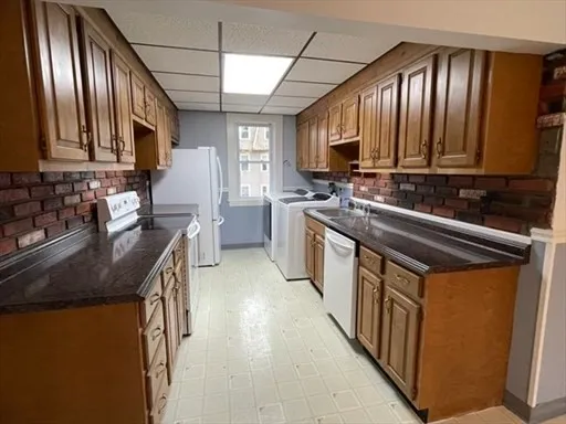 a kitchen with stainless steel appliances granite countertop a sink stove and cabinets