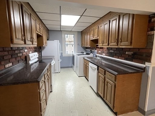 57 Vale Street, Unit 2 Worcester, MA 01604 - Photo 7 of 13 a kitchen with stainless steel appliances granite countertop a sink stove and cabinets