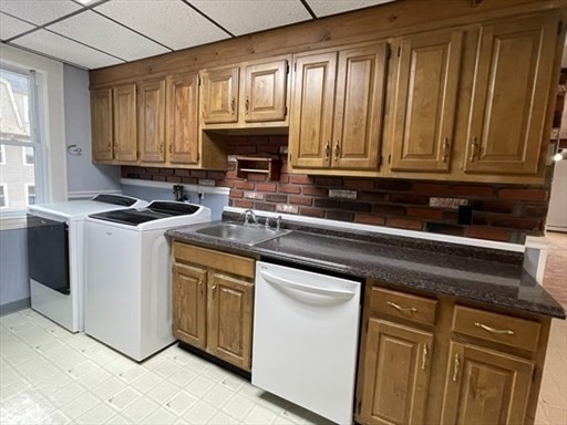 57 Vale Street, Unit 2 Worcester, MA 01604 - Photo 8 of 13 a kitchen with granite countertop a sink stainless steel appliances and cabinets