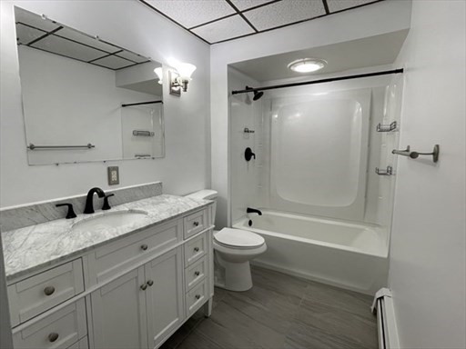 57 Vale Street, Unit 2 Worcester, MA 01604 - Photo 10 of 13 a bathroom with a granite countertop sink toilet and shower