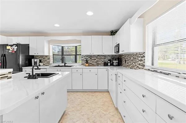 a kitchen with stainless steel appliances a sink stove and cabinets