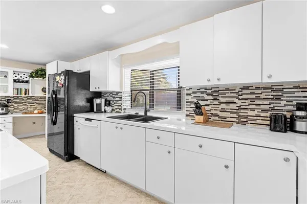 a kitchen with stainless steel appliances a sink stove and refrigerator