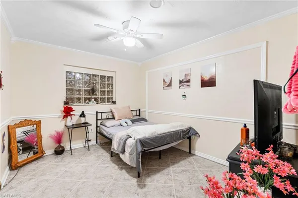 a bedroom with bed and a flat screen tv