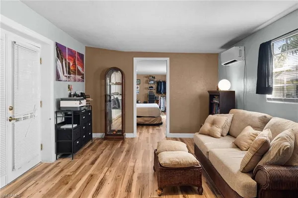 a bedroom with furniture and a wooden floor