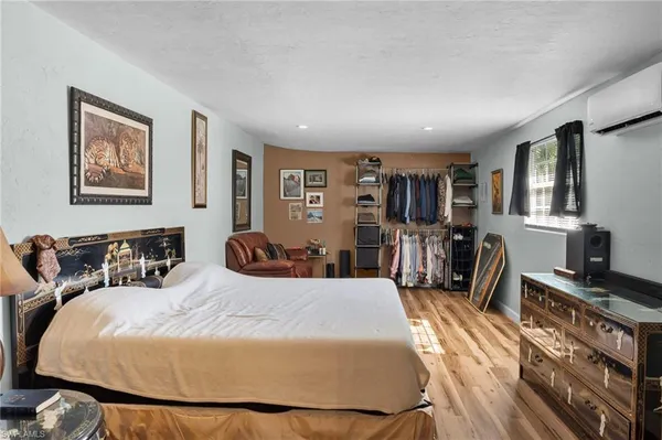 a bedroom with a bed a desk and chair