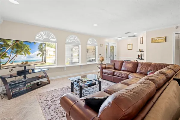 a living room with furniture a large window and a flat screen tv