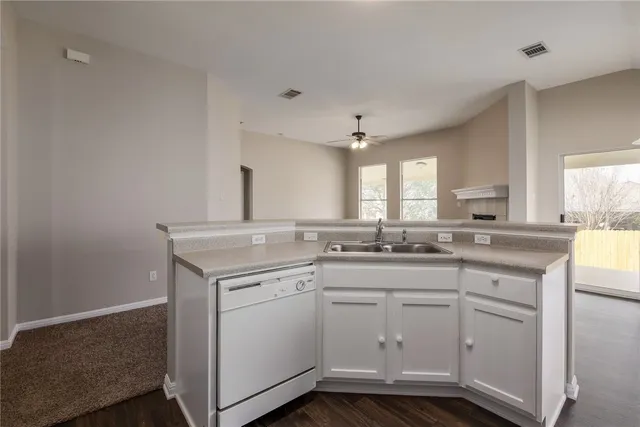 a kitchen with a sink stove and cabinets