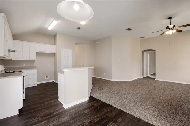 a view of kitchen with cabinets and wooden floor