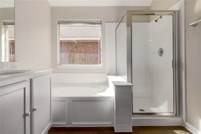a bathroom with a shower and a window