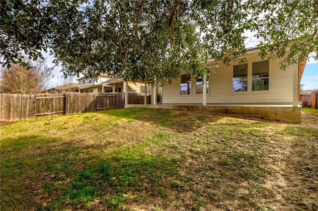 a view of yard with swimming pool and trees around