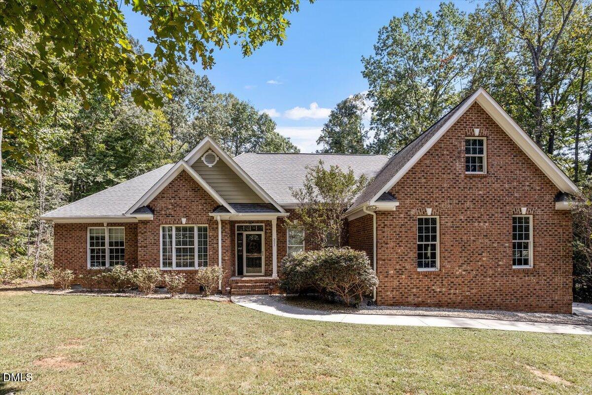 321 Efland - Cedar Grove Road Efland, NC 27243 - Photo 1 of 45 a front view of a house with a yard