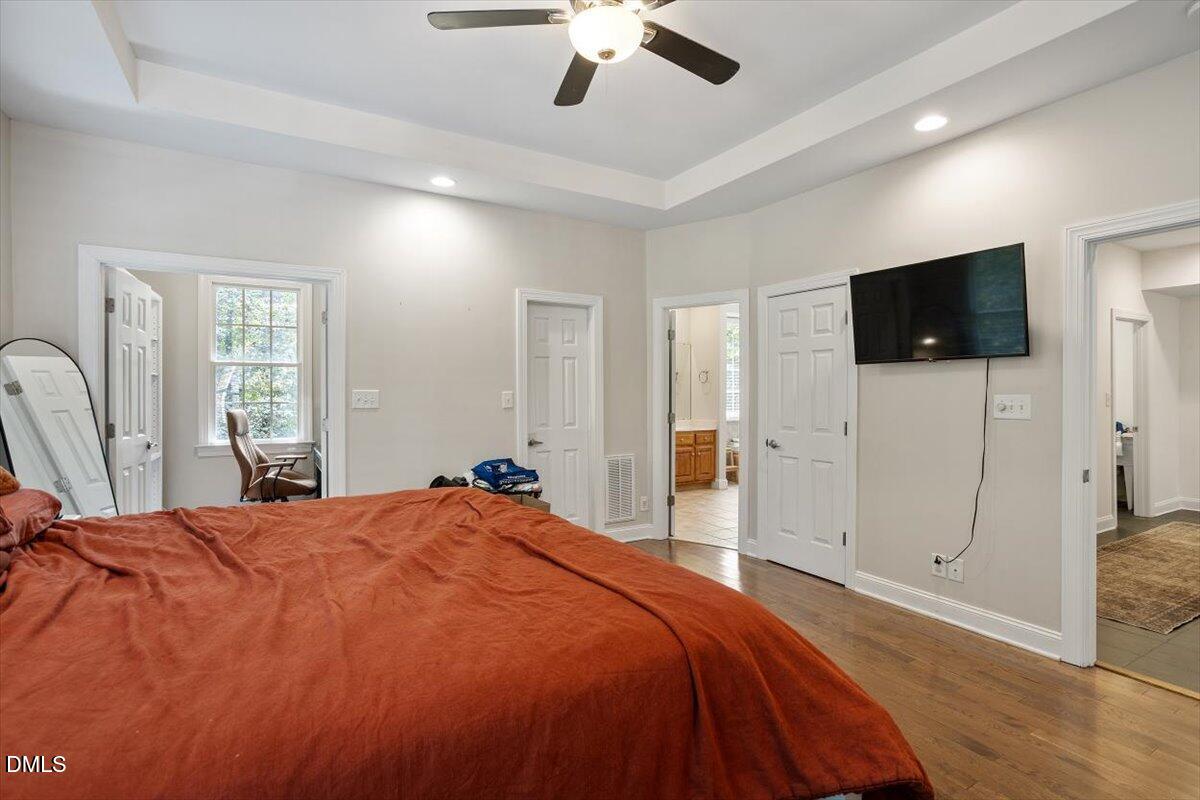 321 Efland - Cedar Grove Road Efland, NC 27243 - Photo 19 of 45 a bedroom with a bed and a flat screen tv