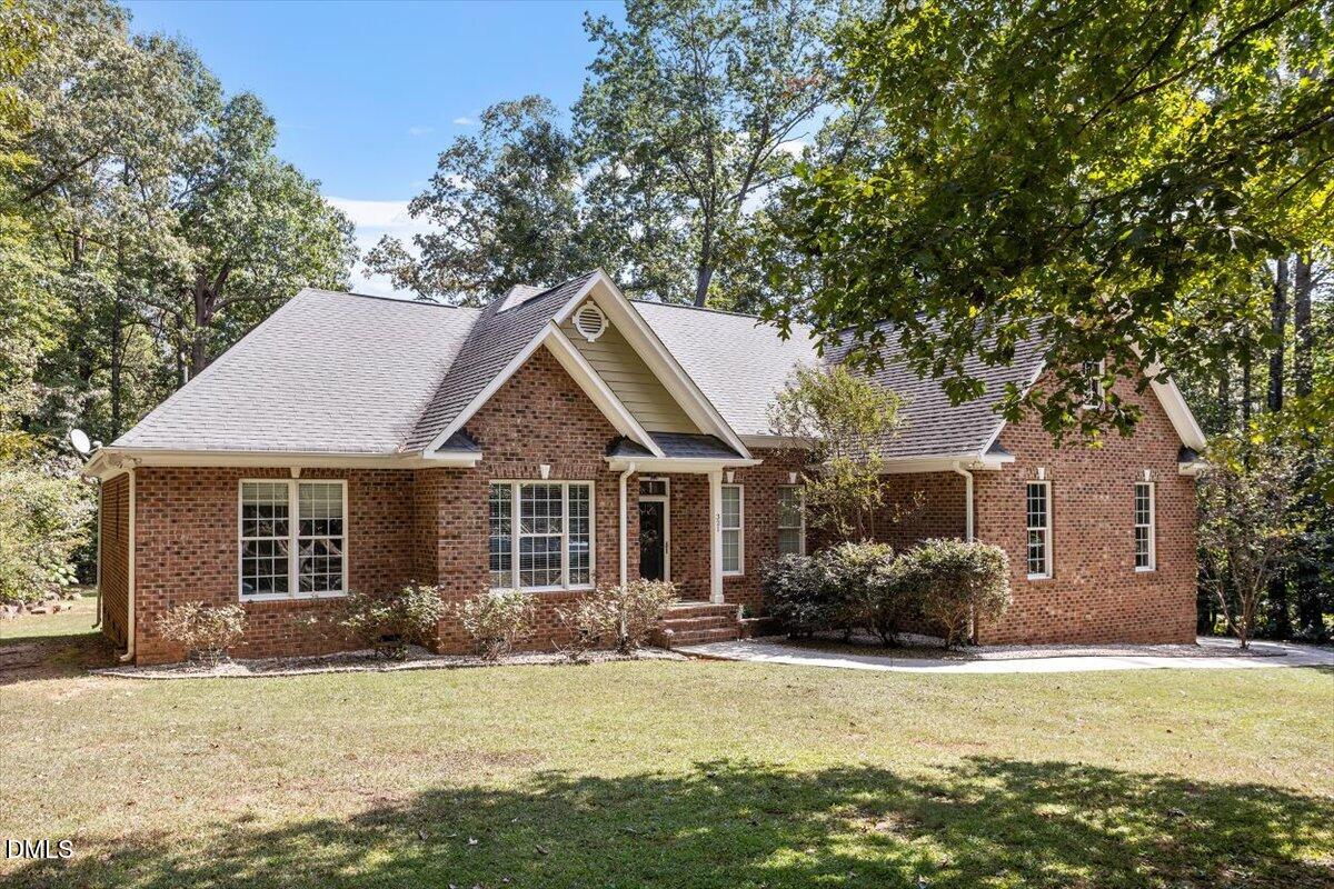 321 Efland - Cedar Grove Road Efland, NC 27243 - Photo 2 of 45 a front view of a house with a yard