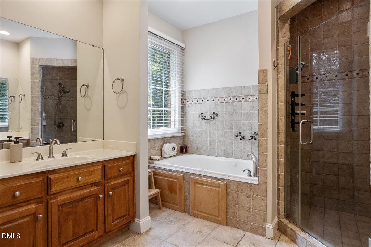 321 Efland - Cedar Grove Road Efland, NC 27243 - Photo 21 of 45 a bathroom with a double vanity sink a large mirror and shower