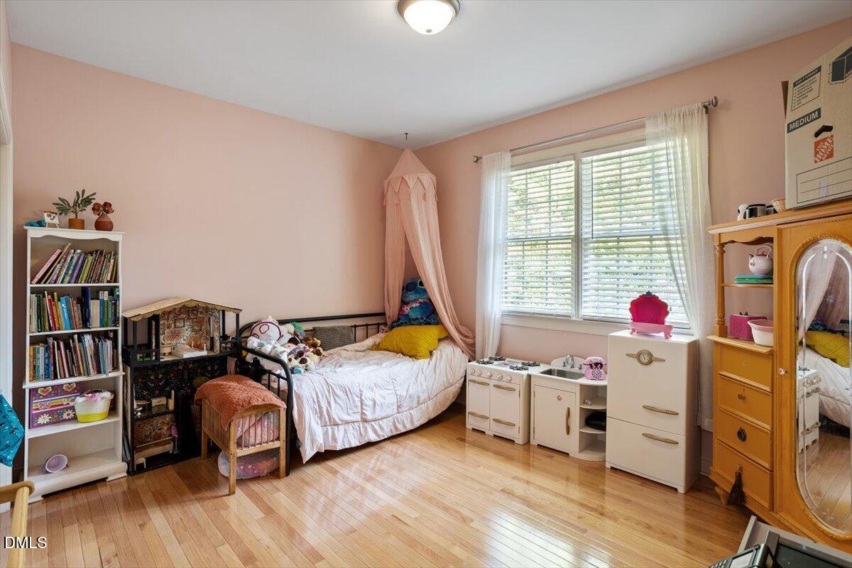 321 Efland - Cedar Grove Road Efland, NC 27243 - Photo 25 of 45 a bedroom with furniture and a wooden floor