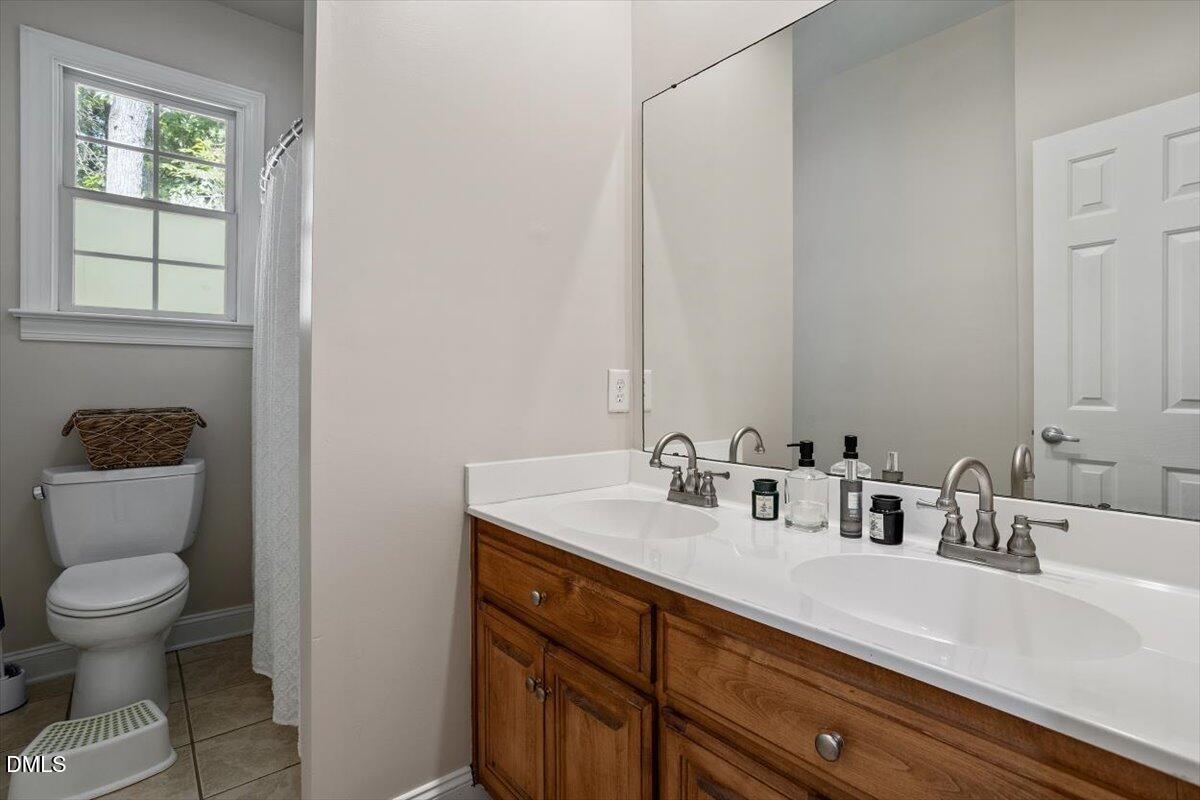 321 Efland - Cedar Grove Road Efland, NC 27243 - Photo 27 of 45 a bathroom with a toilet sink and mirror