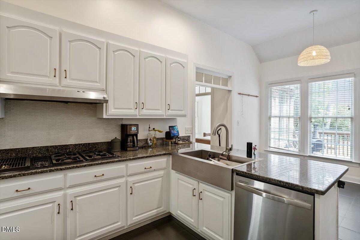 321 Efland - Cedar Grove Road Efland, NC 27243 - Photo 4 of 45 a kitchen with stainless steel appliances granite countertop a sink a stove cabinets and a window