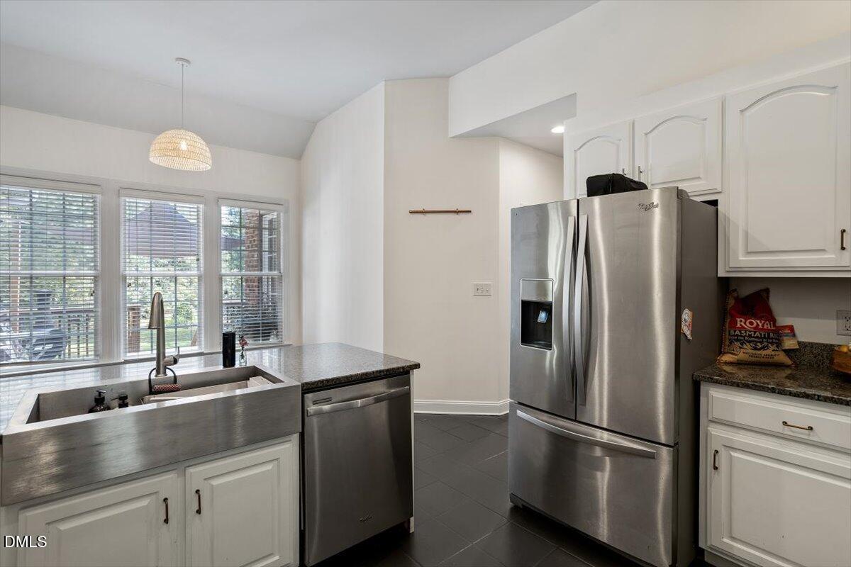 321 Efland - Cedar Grove Road Efland, NC 27243 - Photo 5 of 45 a kitchen with stainless steel appliances granite countertop a refrigerator and a sink