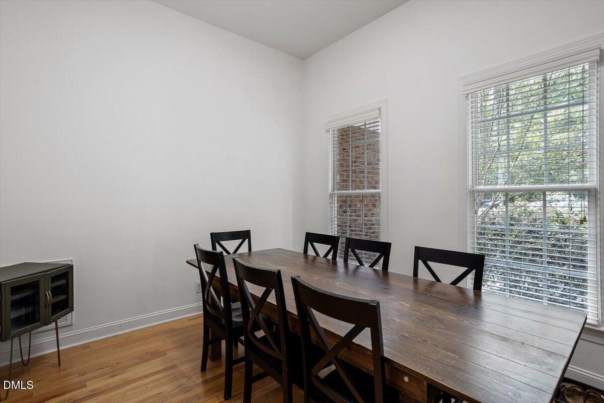 321 Efland - Cedar Grove Road Efland, NC 27243 - Photo 8 of 45 a view of a dining room with furniture and wooden floor