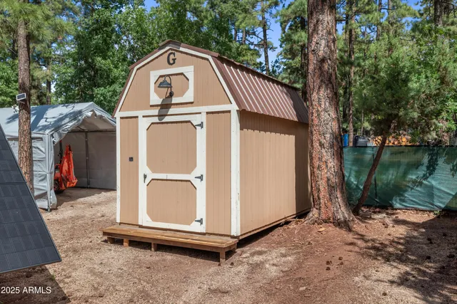 a view of a small house with a fence