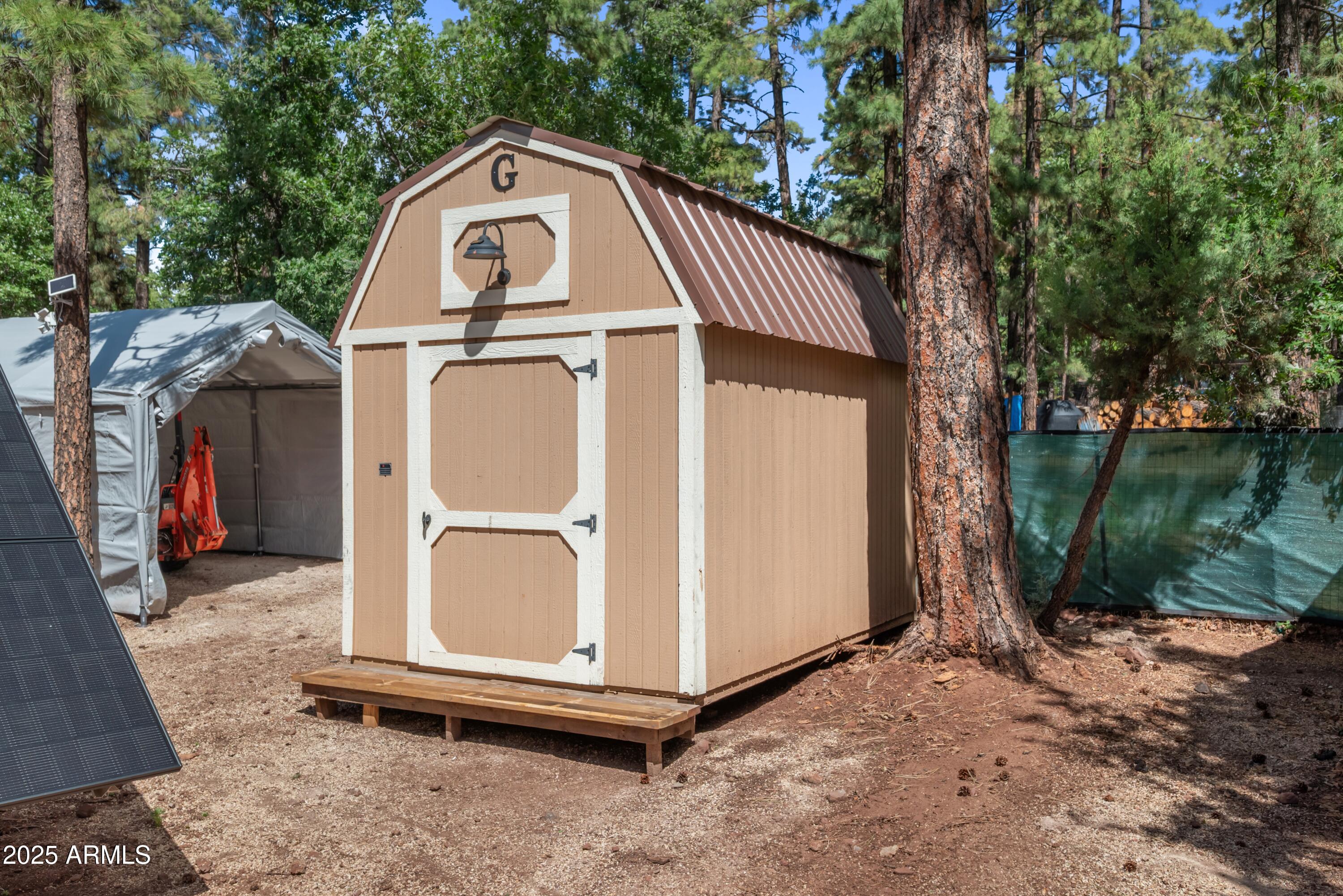 1659 Mormon Road Happy Jack, AZ 86024 - Photo 29 of 46 a view of a small house with a fence