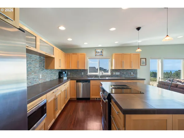 a kitchen with a sink microwave and cabinets