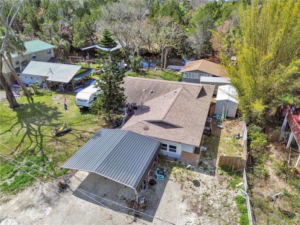 an aerial view of a house with a yard