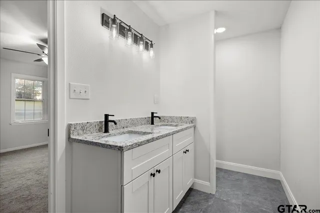 a view of a livingroom with a ceiling fan and window