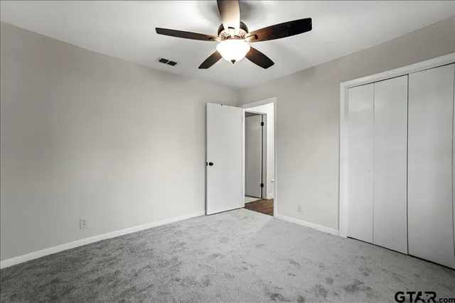 a bathroom with a granite countertop sink a shower and a mirror