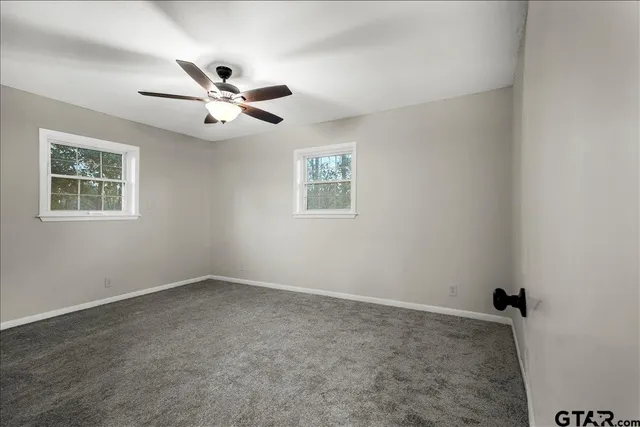 a bathroom with a granite countertop sink a toilet and shower