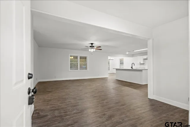 a kitchen with stainless steel appliances granite countertop grey cabinets a stove a sink and dishwasher