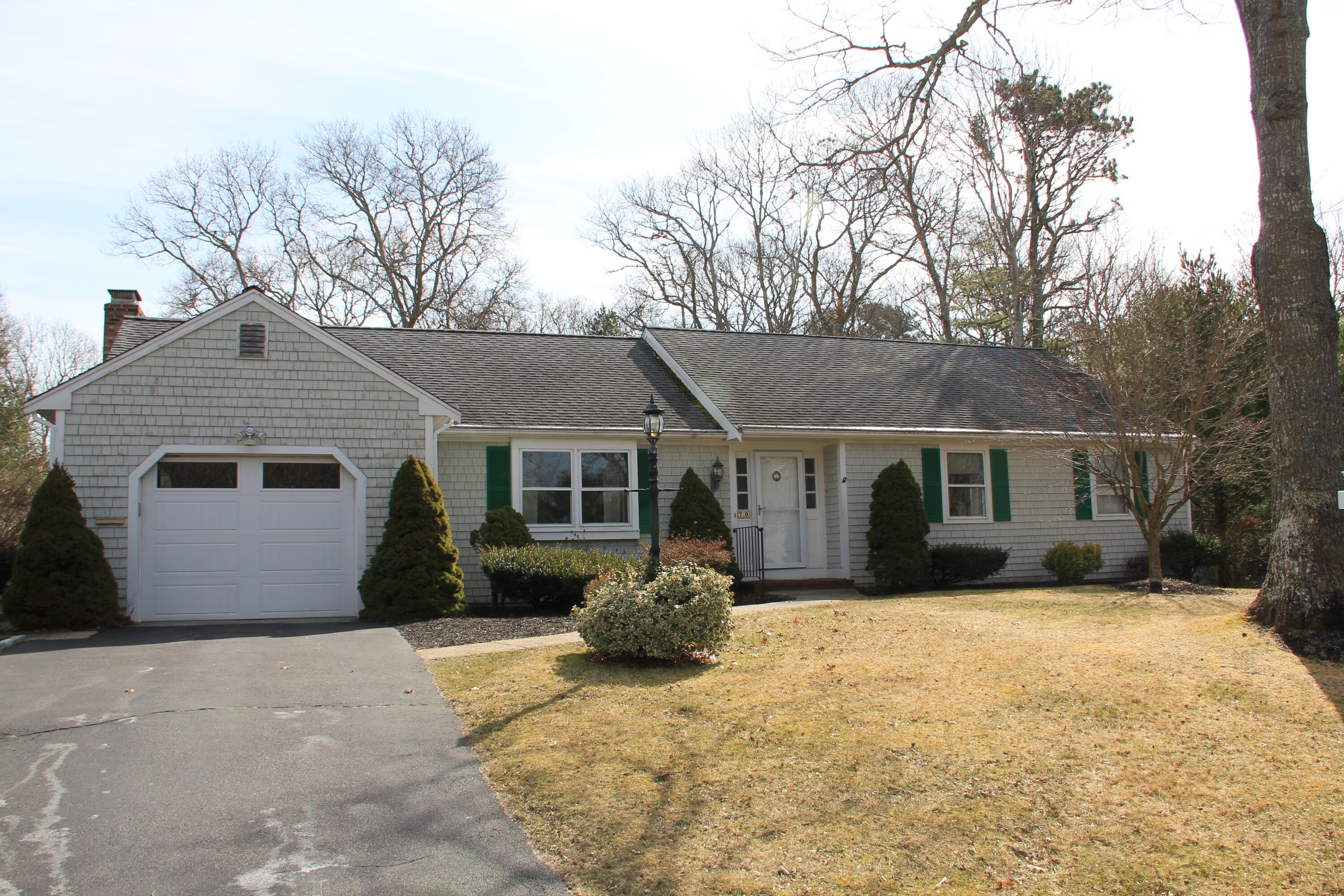 70 Padlock Lane Centerville, MA 02632 - Photo 1 of 23 a front view of a house with a yard covered in snow