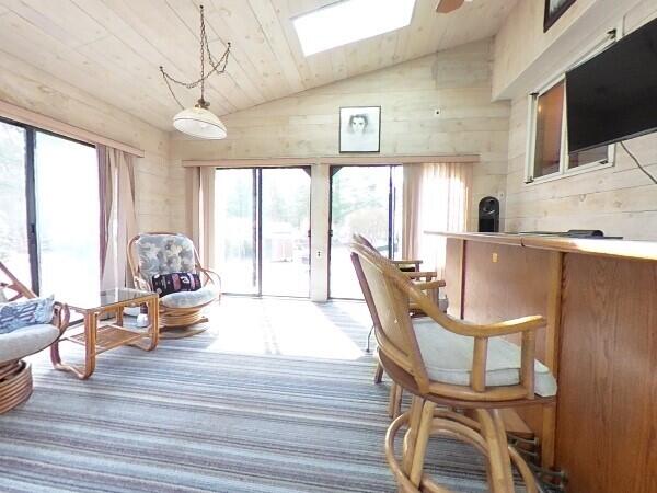 70 Padlock Lane Centerville, MA 02632 - Photo 18 of 23 a living room with furniture a flat screen tv and a large window