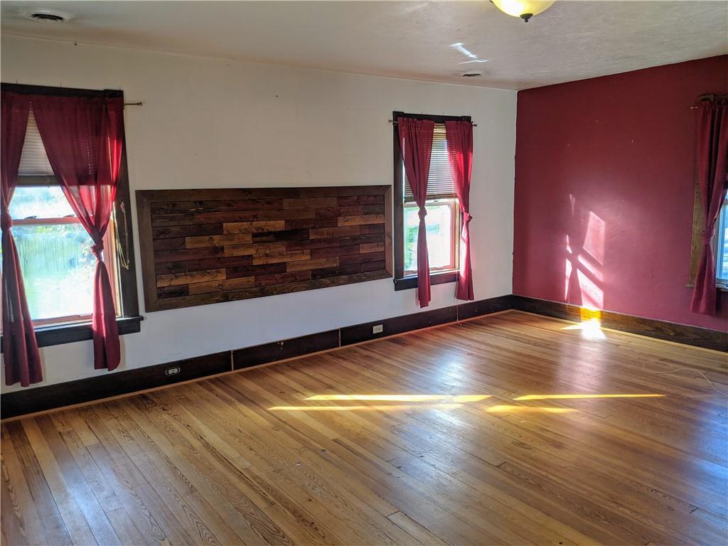 124 Chartiers Road Jefferson, PA 15344 - Photo 15 of 22 a view of an empty room with wooden floor and a window