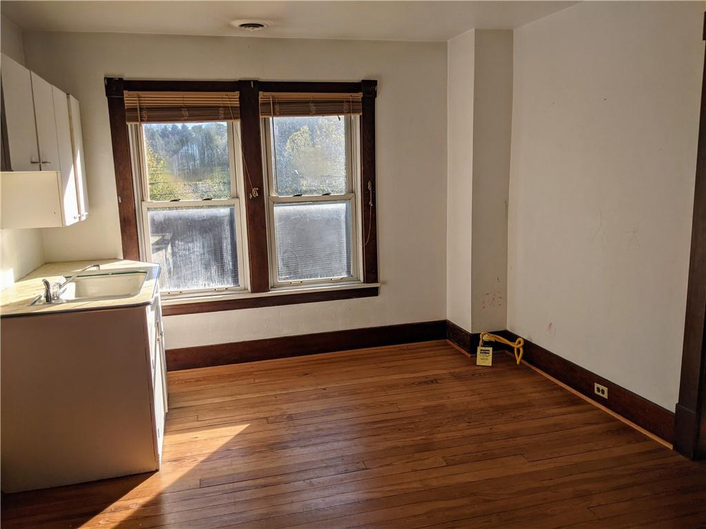 124 Chartiers Road Jefferson, PA 15344 - Photo 19 of 22 a view of an empty room with a window and wooden floor