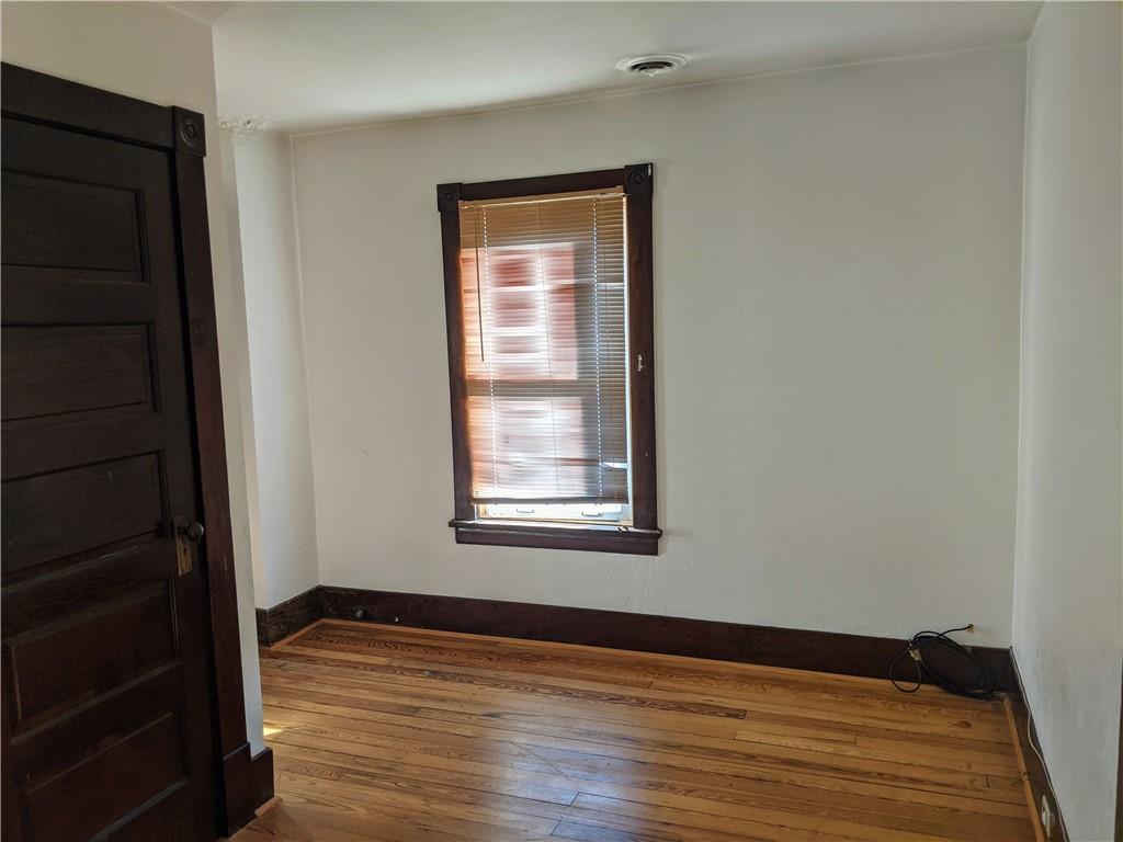 124 Chartiers Road Jefferson, PA 15344 - Photo 22 of 22 a view of an empty room with wooden floor and a window