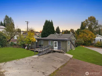 a view of a house with a yard porch and sitting area