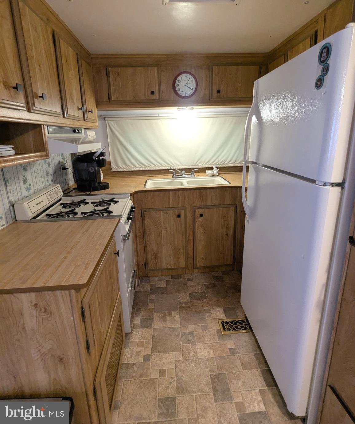10 Old Faceful Road Falling Waters, WV 25419 - Photo 16 of 19 a kitchen with a refrigerator and a stove