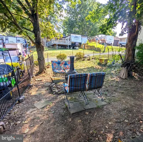 a view of a sitting area with furniture and wooden fence